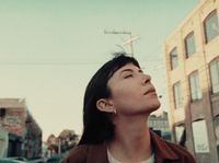 a woman standing in the middle of a street