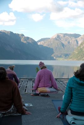 a group of people sitting on top of a wooden dock