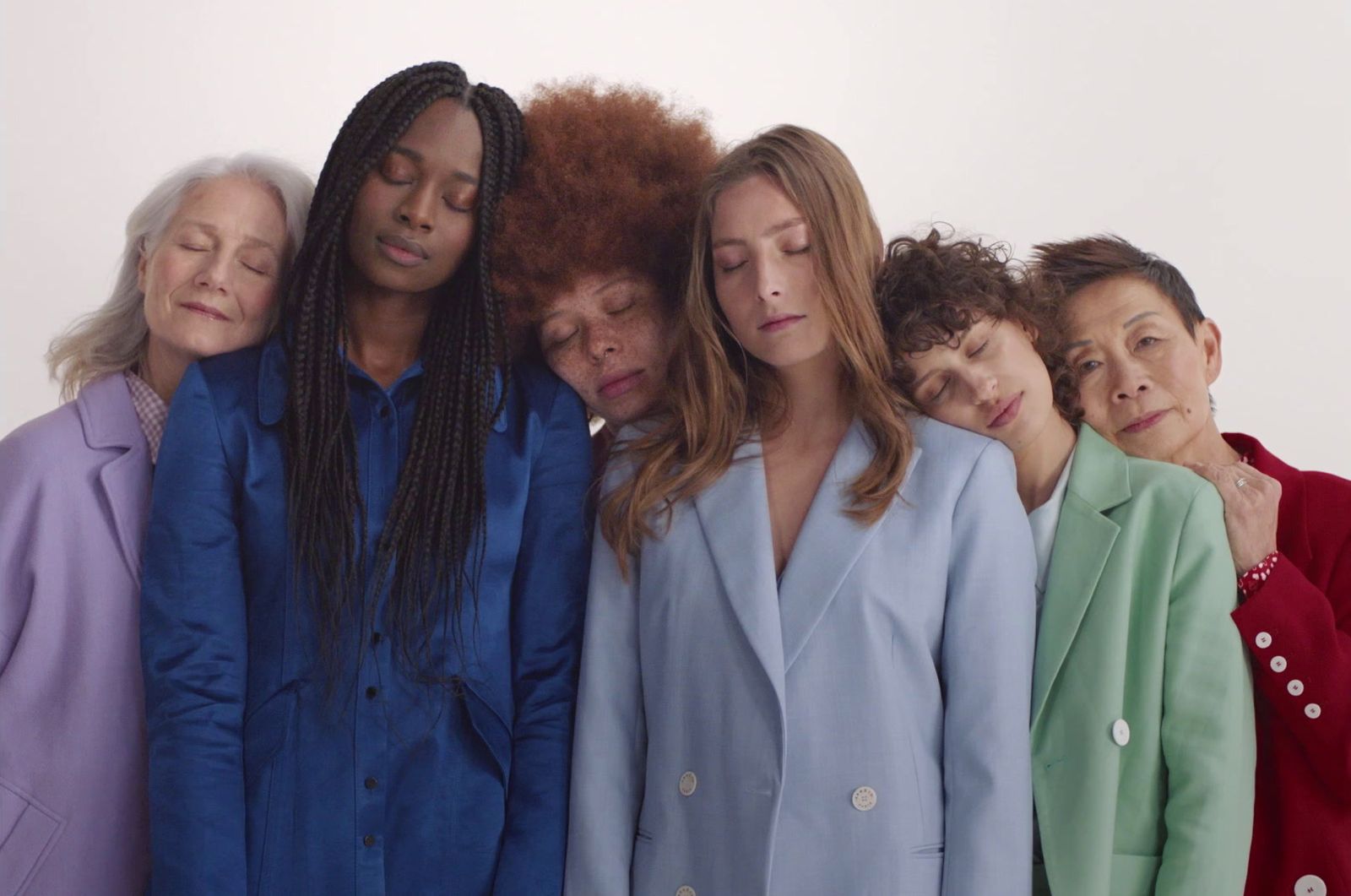 a group of women standing next to each other