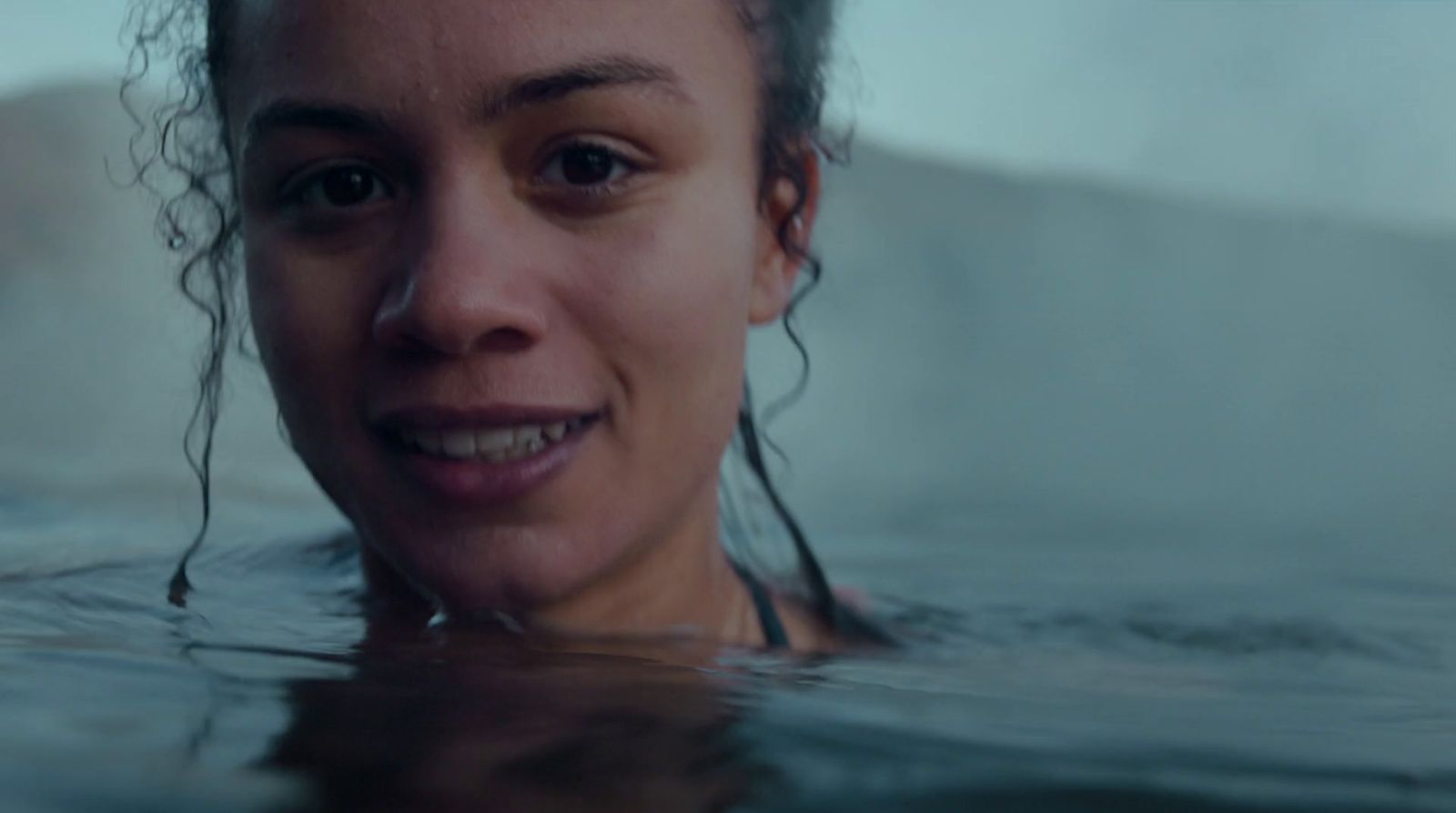 a woman in a hot tub smiling at the camera