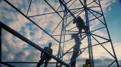 a group of people standing on top of a metal structure