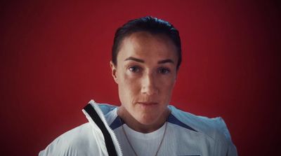 a woman wearing a white jacket and a necklace