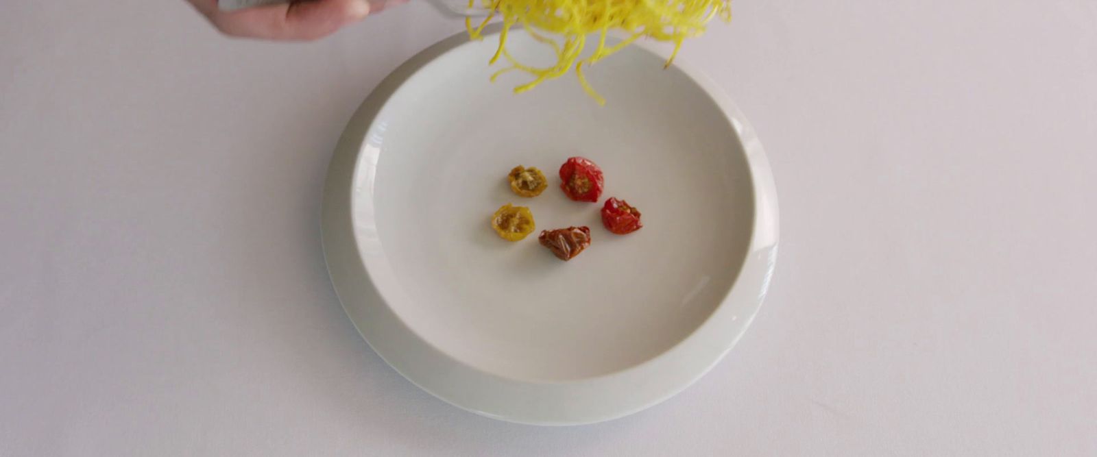 a white plate topped with noodles and fruit