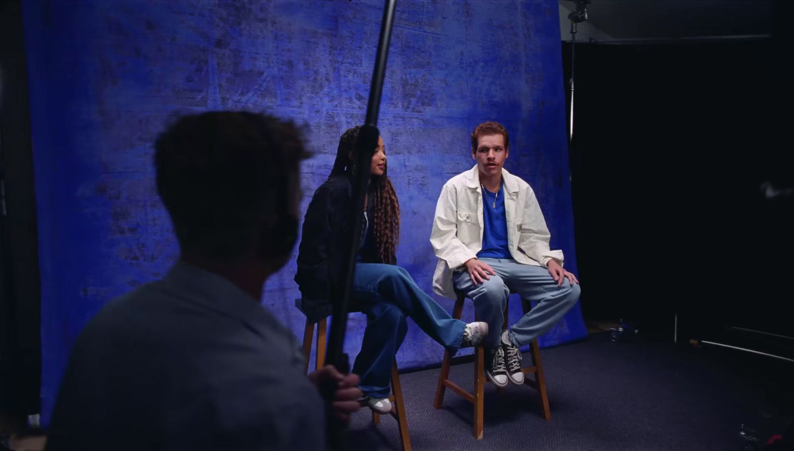 a man sitting in a chair next to a woman