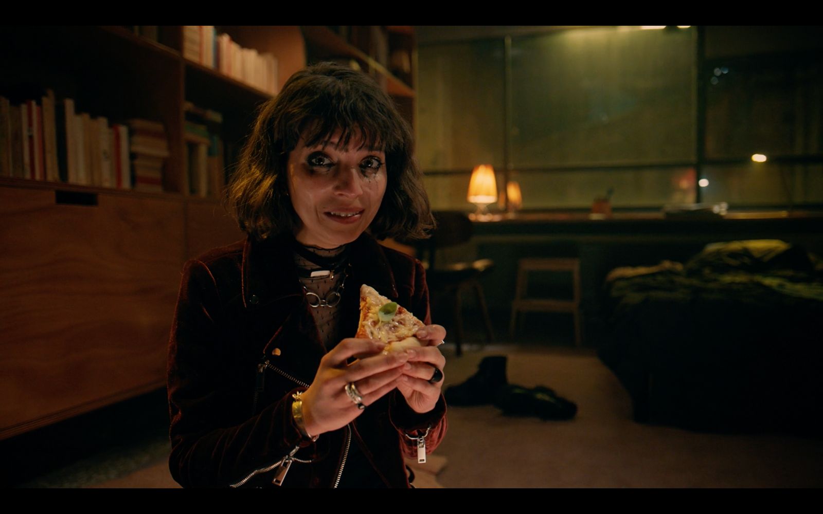 a woman holding a slice of pizza in her hand