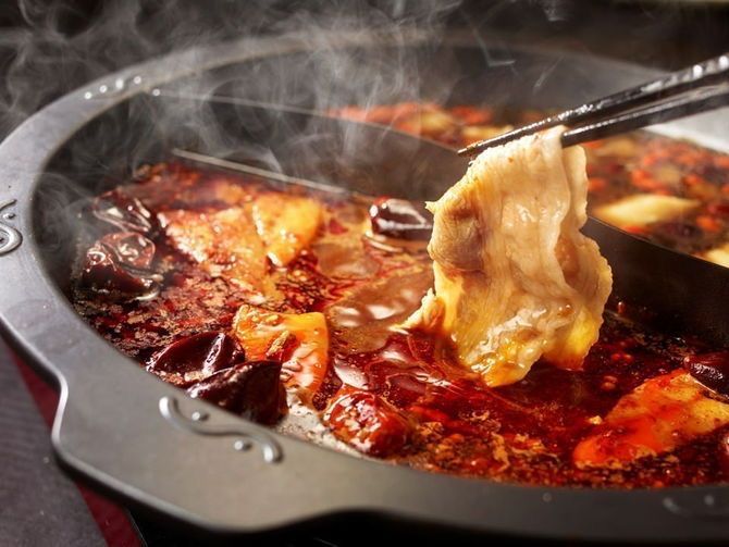 a pan filled with food and a spatula in it