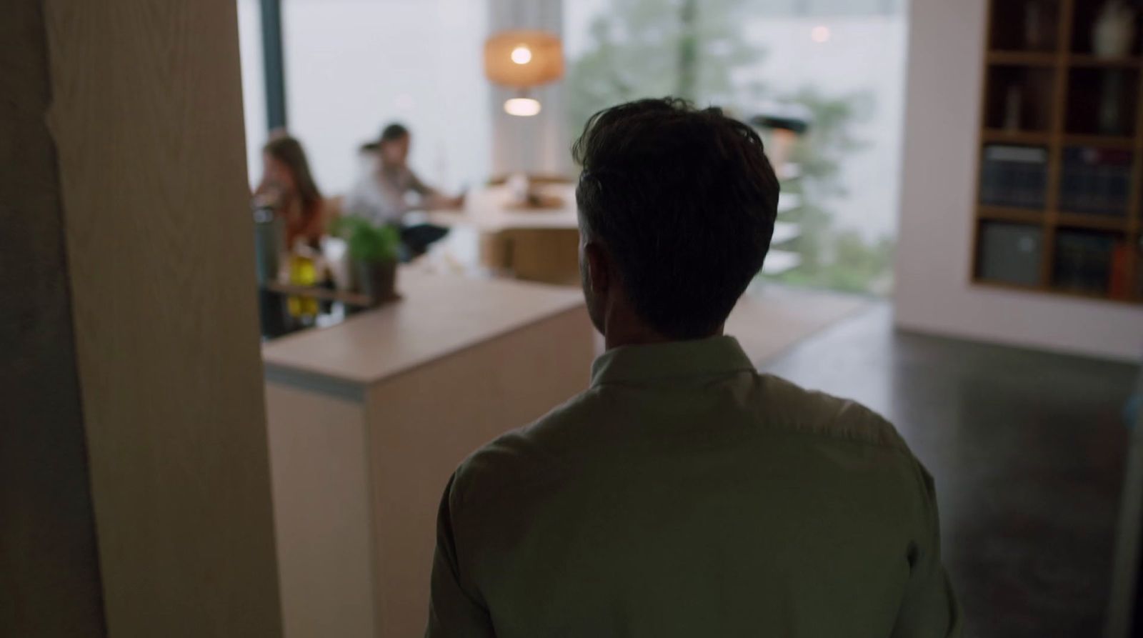 a man standing in front of a kitchen counter