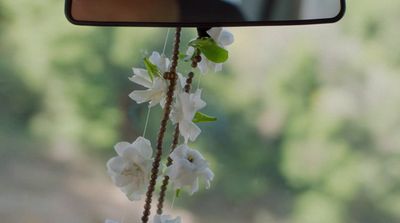 a rear view mirror with flowers hanging from it