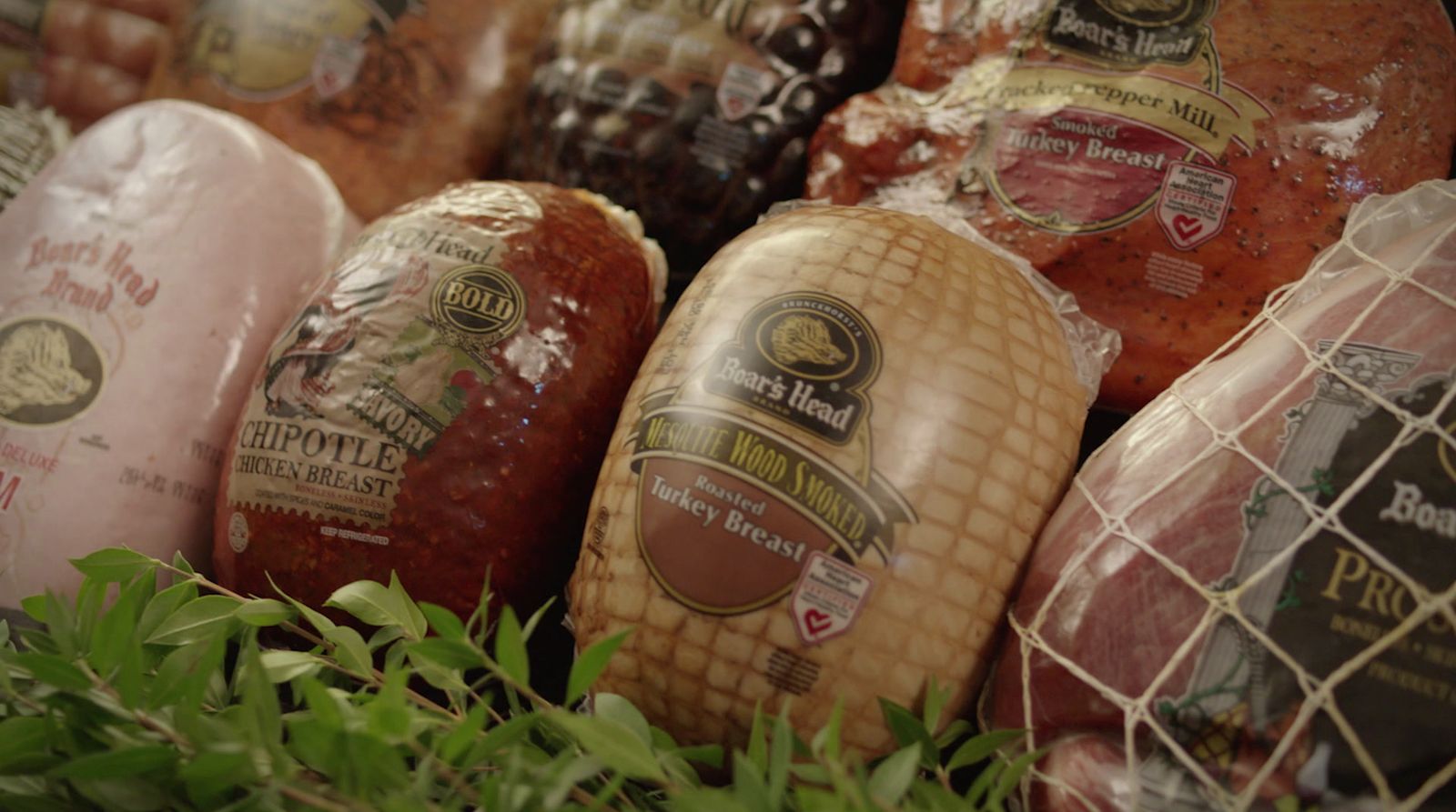 a bunch of sausages are in a display case