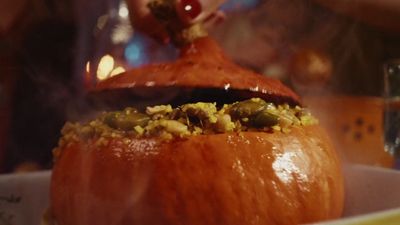 a close up of a pumpkin with food inside of it