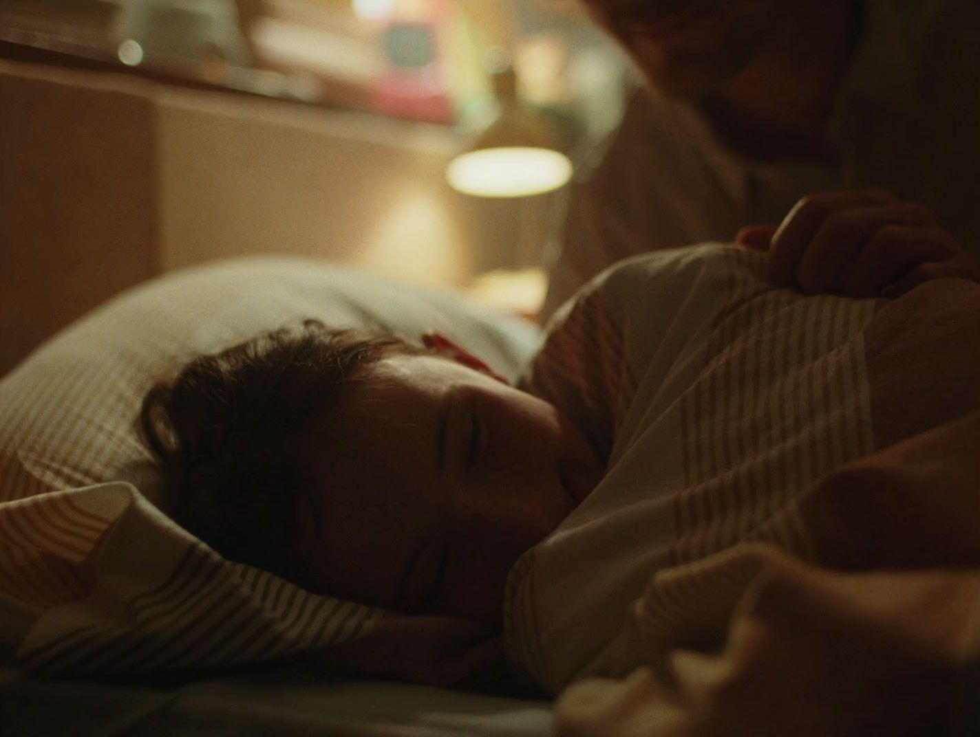 a woman laying in bed next to a man