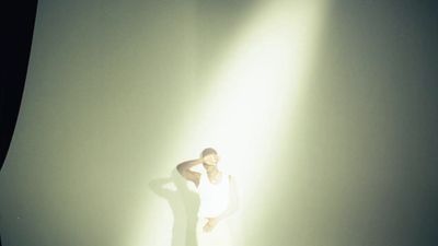 a woman standing in front of a white wall