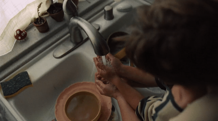 a person washing their hands in a sink