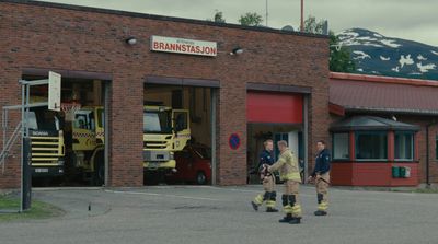 a group of men standing outside of a fire station