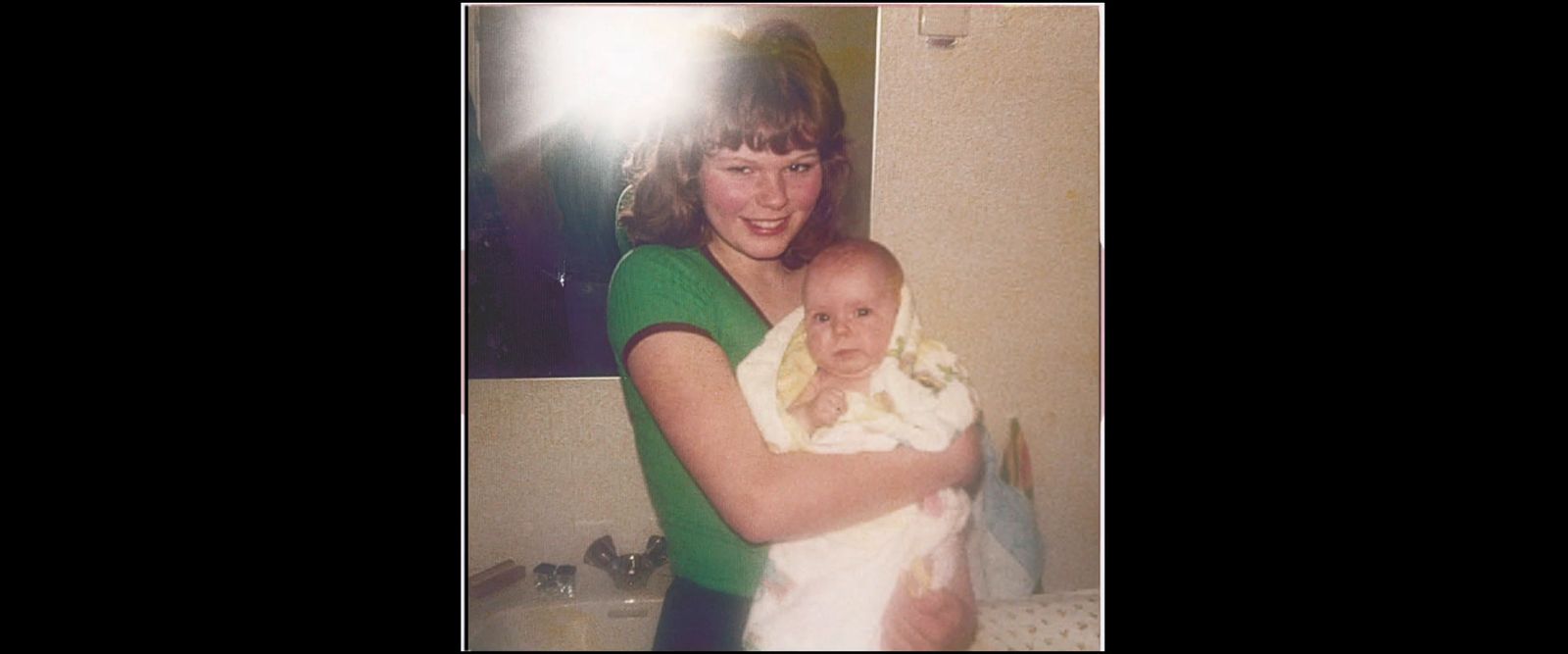 a woman holding a baby in her arms