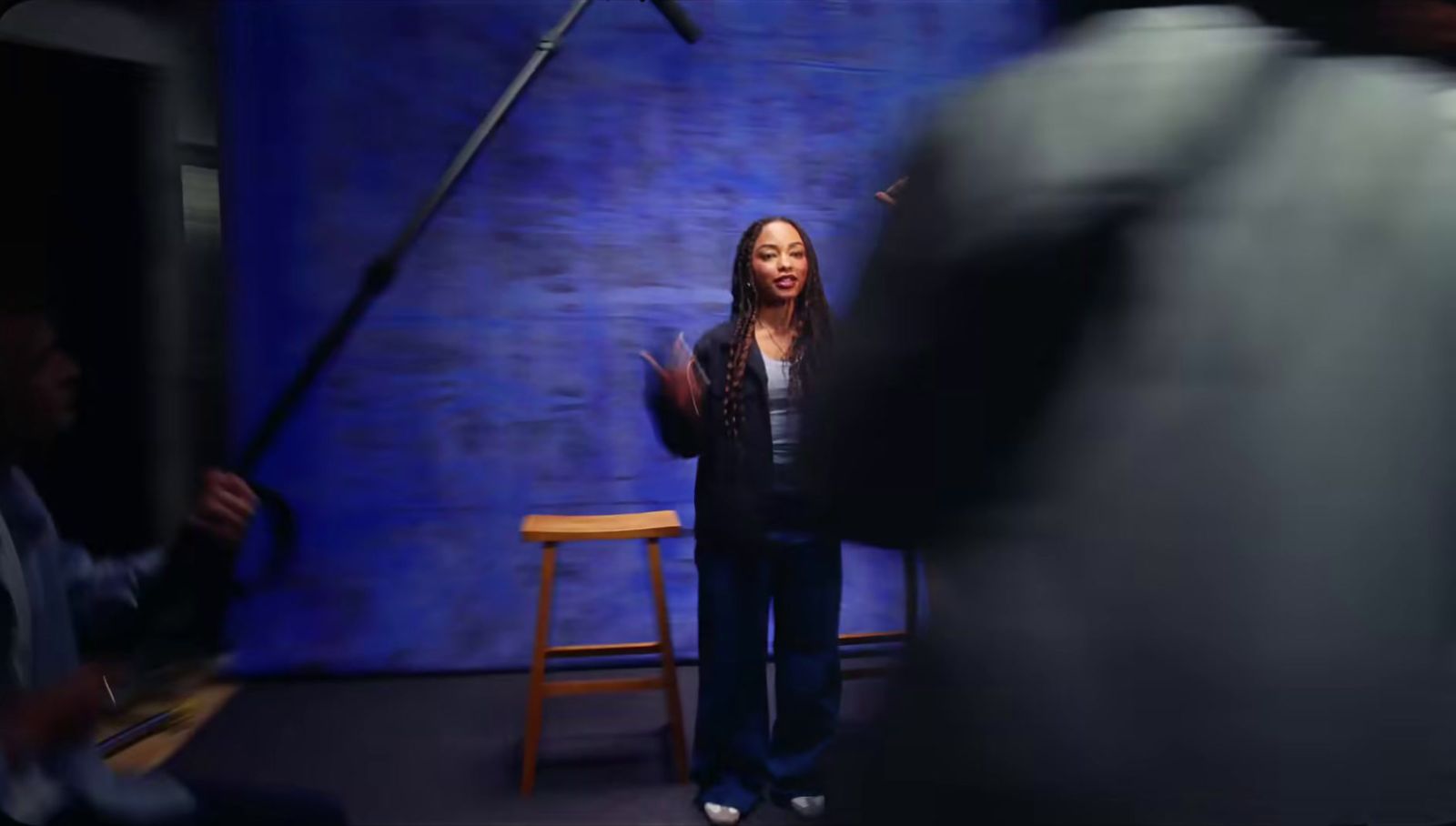 a woman standing in front of a blue background