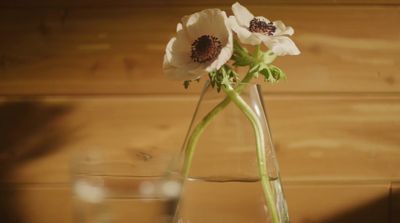 a glass vase with some flowers in it