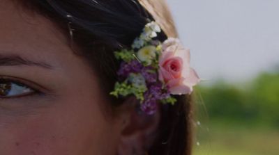 a woman with a flower in her hair