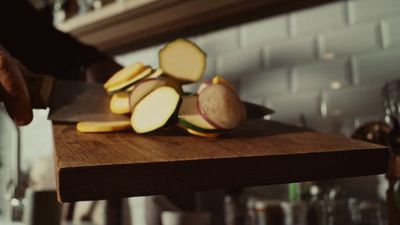 a person chopping apples on a cutting board