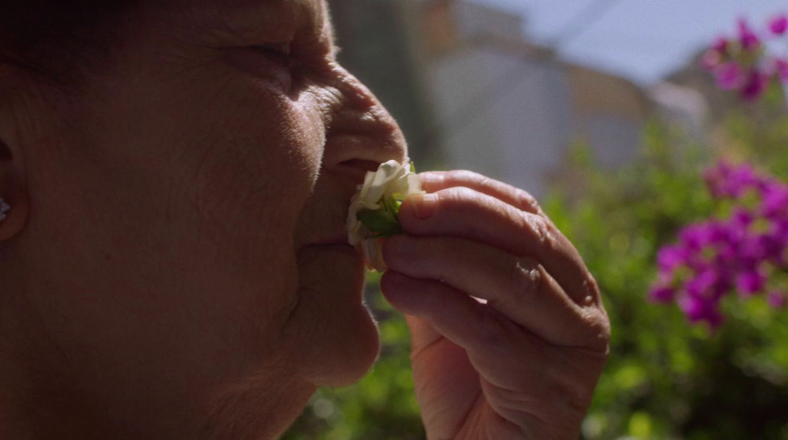 a woman eating a piece of food in her hand