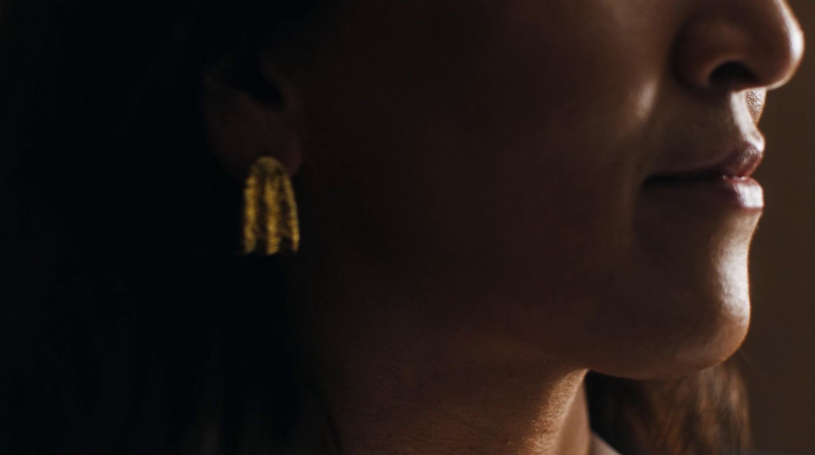 a close up of a person wearing earrings