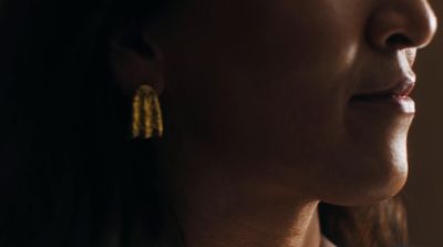 a close up of a person wearing earrings