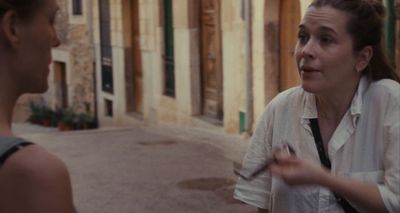 a woman talking to another woman on the street