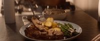 a plate of food with meat, potatoes and broccoli