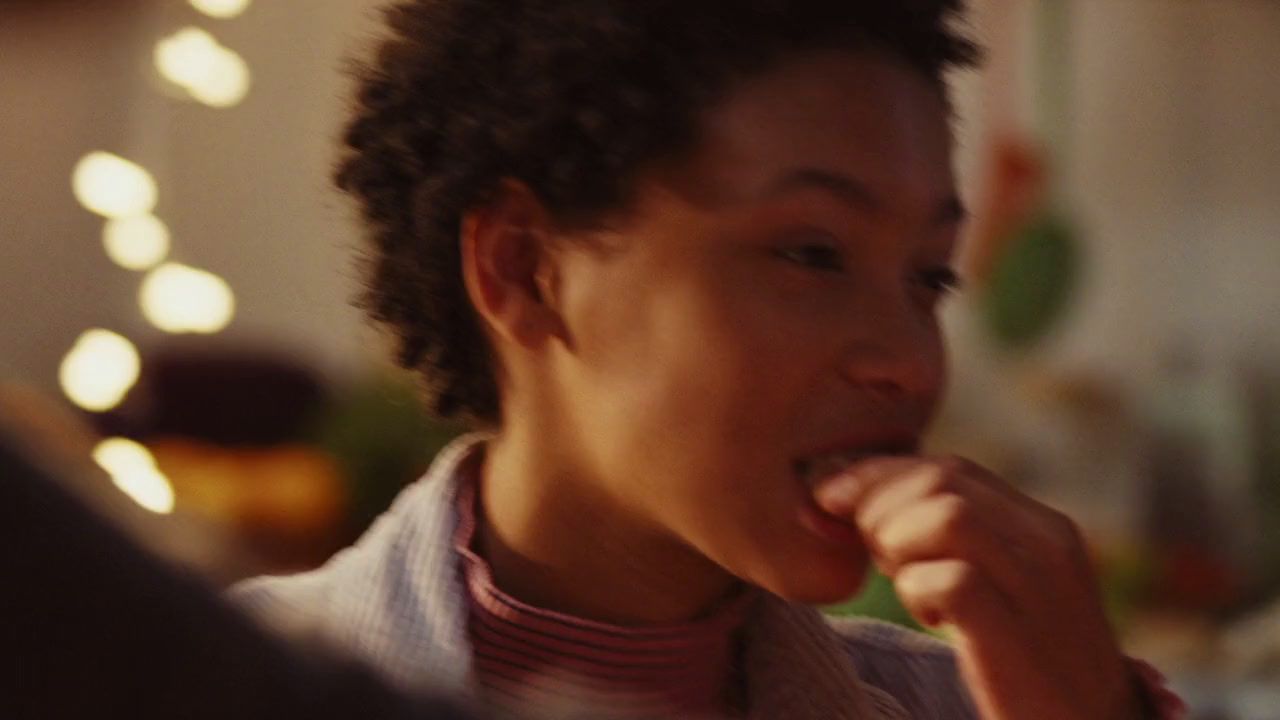 a young man is eating a piece of food