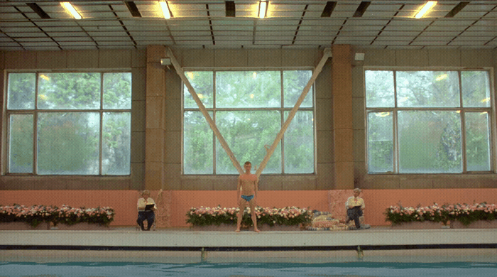 a group of people standing on top of a swimming pool