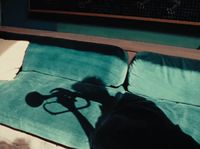 a shadow of a person laying on a couch
