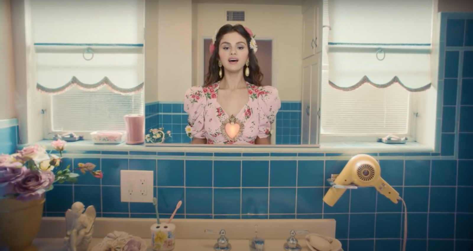 a woman standing in front of a bathroom mirror