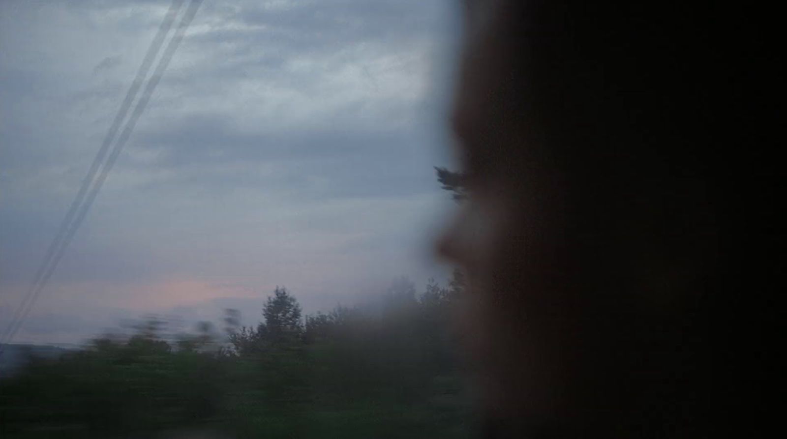 a blurry photo of a person looking out a window