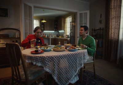 a man and a woman sitting at a table eating food