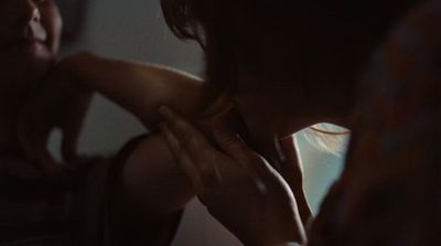 a woman is holding her hand up to her chest