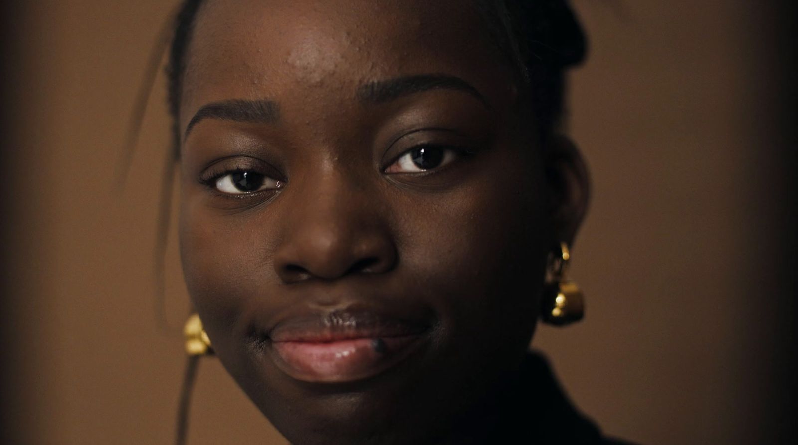 a close up of a person wearing earrings