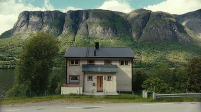 a house with a mountain in the background