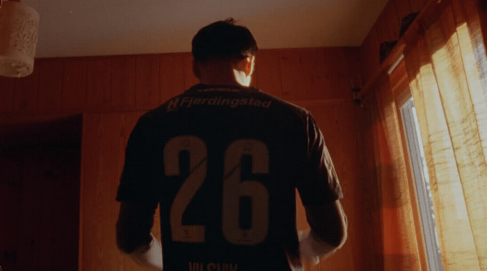 a man standing in front of a window in a room