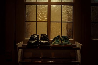 a pair of shoes sitting on top of a window sill