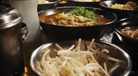 a table topped with lots of bowls of food