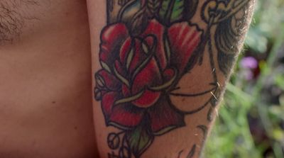 a close up of a person with a tattoo on his arm