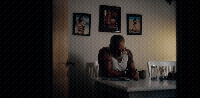 a man sitting at a table with a book in front of him