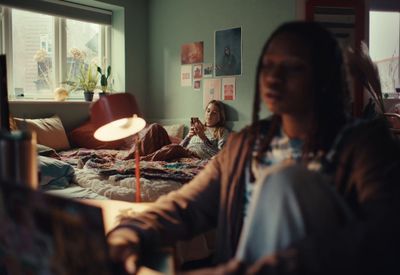 a woman sitting on a bed in a room