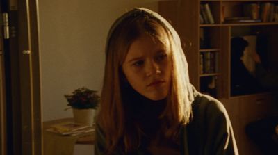 a woman with long hair standing in a room