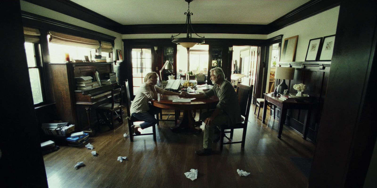 a group of people sitting around a wooden table