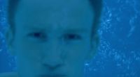 a man in a swimming pool looking at the camera