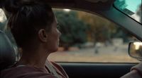 a woman sitting in a car with her head out the window