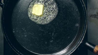 a frying pan with a piece of butter in it