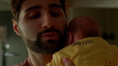 a man holding a baby in his arms