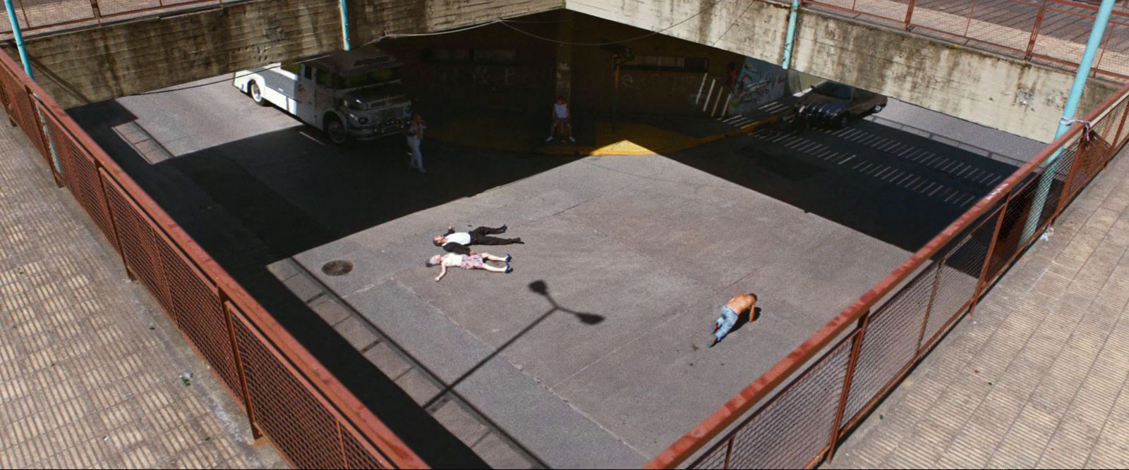 a couple of people standing on top of a parking lot